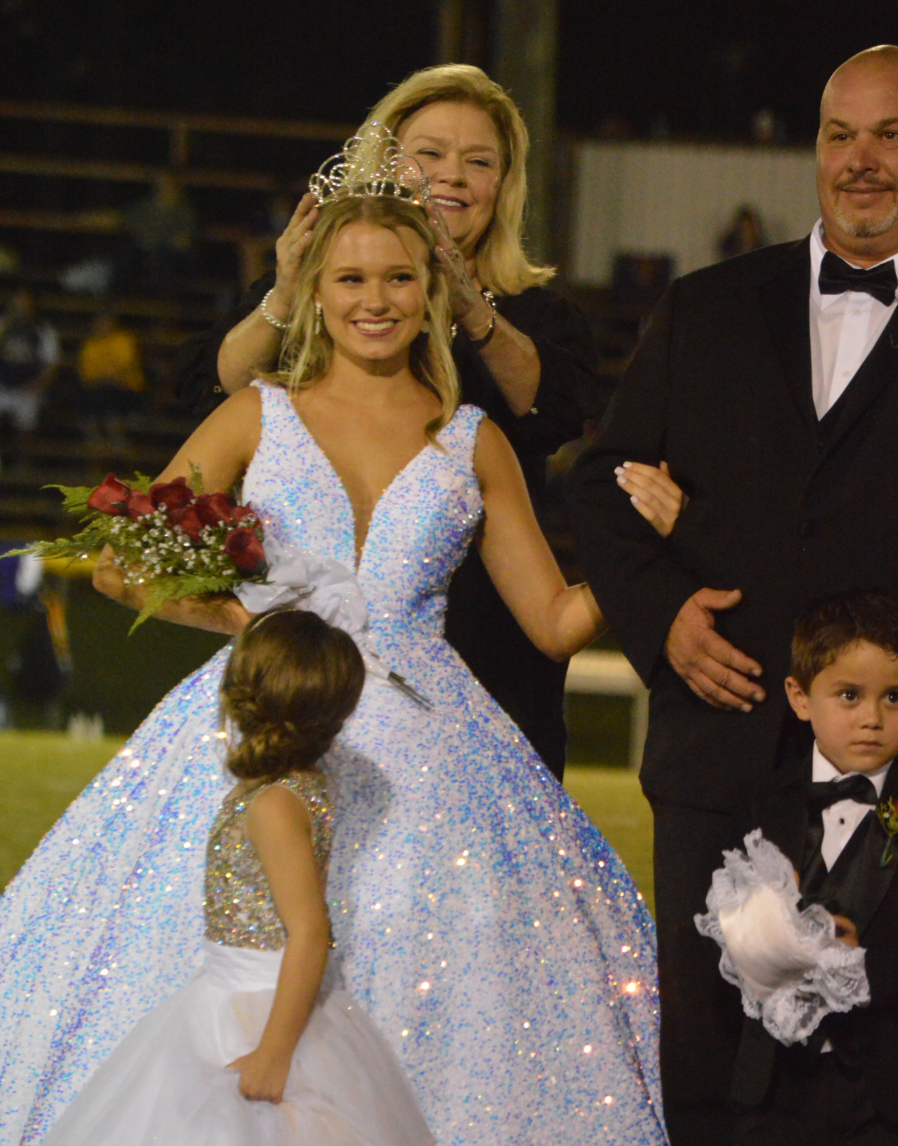 Headmaster Angie Burkett crowns Emily Regan as Homecoming Queen.