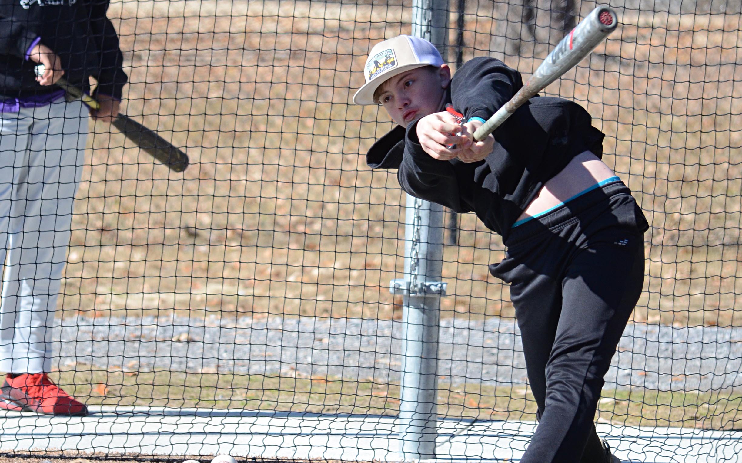Devin Beach hits a line drive in the batting cage.