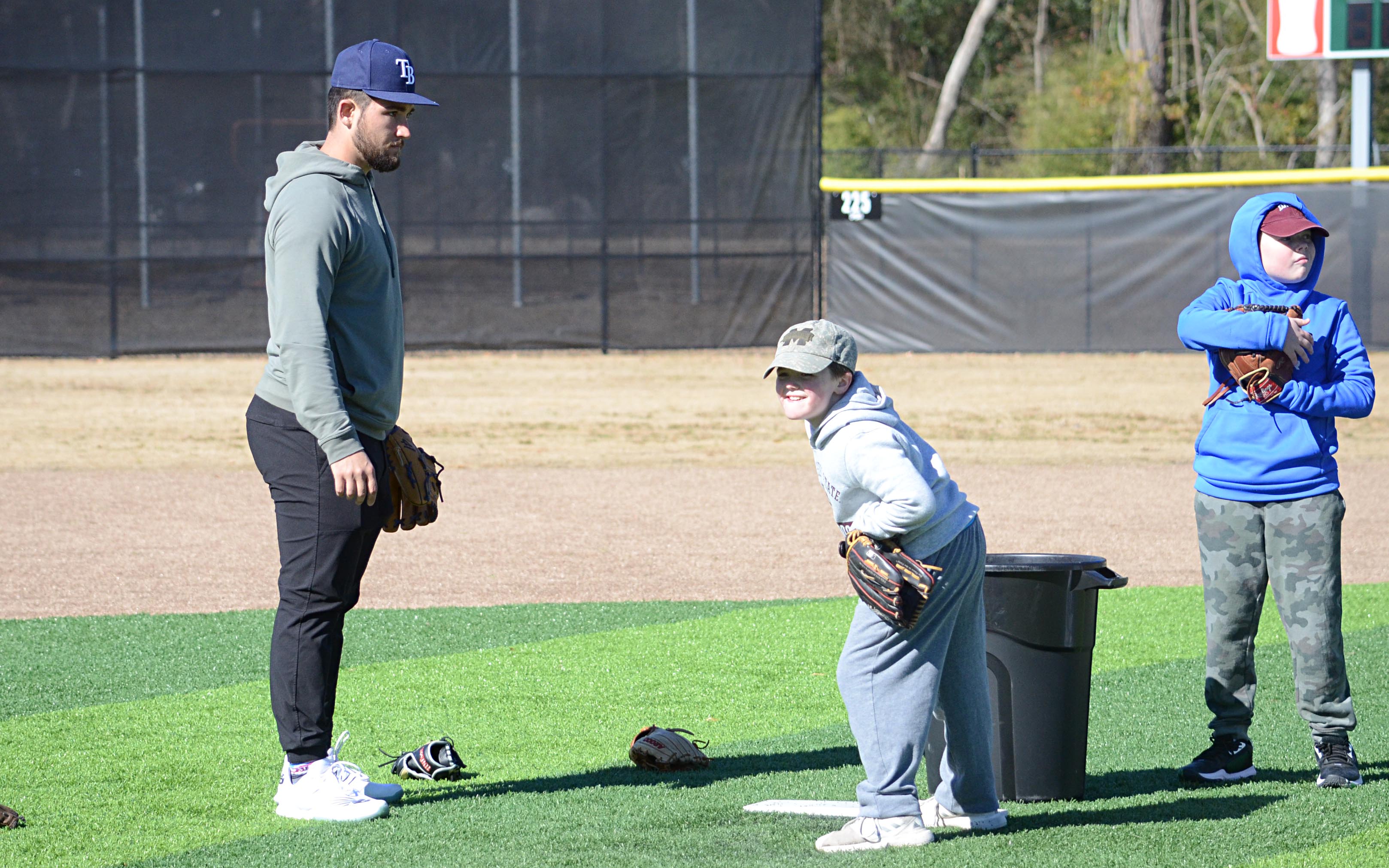 Colby White instructs Max Jordan on pitching.