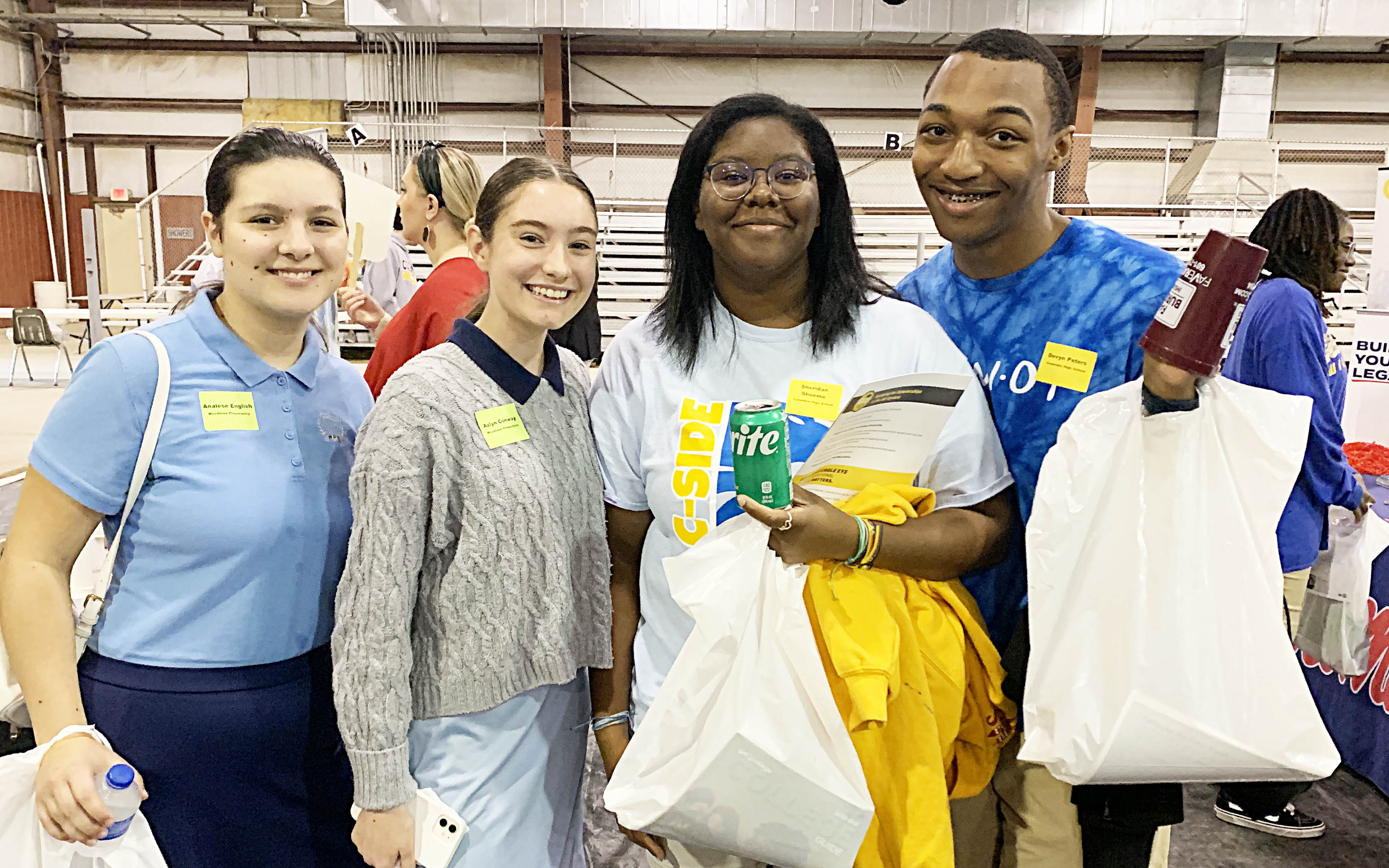 Analese English and Azlyn Conway of Woodlawn Prep show off their swag from the Career Fair with Sheridan Shoemo and Devyn Peters of Columbia High School.