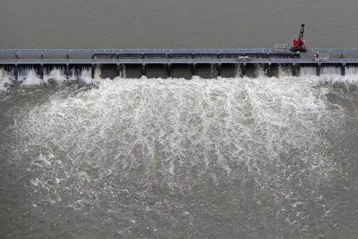 Workers open bays of the Bonnet Carre Spillway to divert rising water from the Mississippi River to Lake Pontchartrain, upriver from New Orleans, in Norco, La., May 10, 2019. A federal judge ruled Wednesday, Jan. 18, 2023, that the U.S. Army Corps of Engineers must consult with federal fisheries experts on the effects of opening the spillway that helped prevented Mississippi River flooding in New Orleans, but caused damage to coastal Mississippi marine life and tourism in 2019. (AP Photo/Gerald 