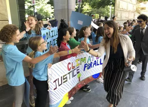Kelsey Juliana, of Eugene, Ore., a lead plaintiff who is part of a lawsuit by a group of young people who say U.S. energy policies are causing climate change and hurting their future, greets supporters outside a federal courthouse, June 4, 2019, in Portland, Ore. A 9th U.S. Circuit Court of Appeals panel on Wednesday, May 1, 2024, rejected a long-running lawsuit brought by young Oregon-based climate activists who argued that the U.S. government's role in climate change violated their constitutio