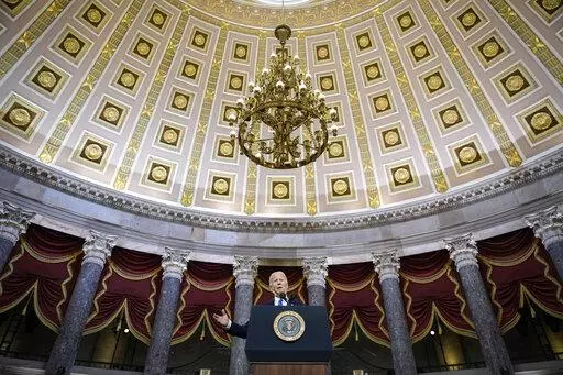 President Joe Biden delivers remarks on the one year anniversary of the January 6 attack on the U.S. Capitol, during a ceremony in Statuary Hall, Thursday,  Jan. 6, 2022 at the Capitol in Washington. (Drew Angerer/Pool via AP)