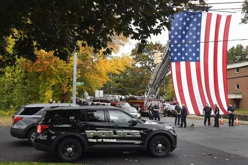 Police officers from Bristol, Conn. gather with other towns at the scene where two police officers killed, Thursday, Oct. 13, 2022, in Bristol, Conn. The deaths of two Connecticut police officers and the wounding of a third during an especially violent week for police across the U.S. fit into a grim pattern, law enforcement experts say. Even as the number of officers has dropped in the past two years, the number being targeted and killed has risen. (AP Photo/Jessica Hill, File)