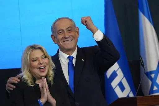 Former Israeli Prime Minister and the head of Likud party, Benjamin Netanyahu and his wife Sara gesture after first exit poll results for the Israeli Parliamentary election at his party's headquarters in Jerusalem, Wednesday, Nov. 2, 2022. (AP Photo/Tsafrir Abayov)