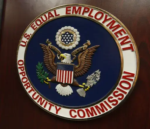 The emblem of the U.S. Equal Employment Opportunity Commission is shown on a podium in Vail, Colo., Tuesday, Feb. 16, 2016, in Denver. A federal judge on Monday, June 17, 2024, granted the U.S. Conference of Catholic Bishops, as well as employers in two Southern states, temporary relief from complying with a federal rule that would have required them to provide workers with time off and other workplace accommodations for abortions. The lawsuits challenge the Equal Employment Opportunity Commissi