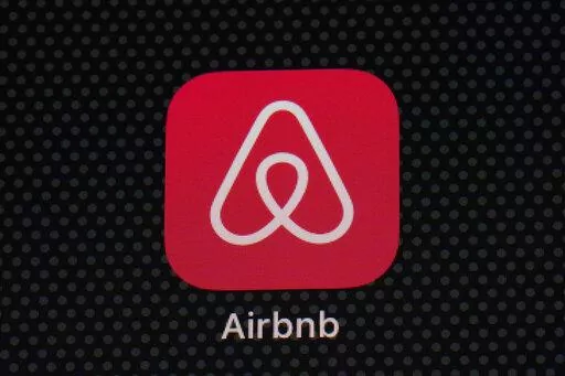 The Airbnb app icon is displayed on an iPad screen in Washington, D.C., on May 8, 2021.  NerdWallet looked at the price of 1,000 Airbnb listings and compared them to the cost of hotels. Airbnbs can be an affordable alternative to hotels, particularly for longer stays, large groups and for people who need a washer and dryer or kitchen. But beware of vacation rental cleaning fees that can make the price skyrocket, and take advantage of discounts for monthlong stays.  (AP Photo/Patrick Semansky, Fi