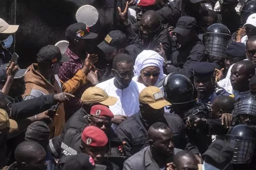 Presidential candidate Amadou Ba and his wife leave a polling station after casting their votes during the presidential elections, in Dakar, Senegal, Sunday, March 24, 2024. (AP Photo/Mosa'ab Elshamy)