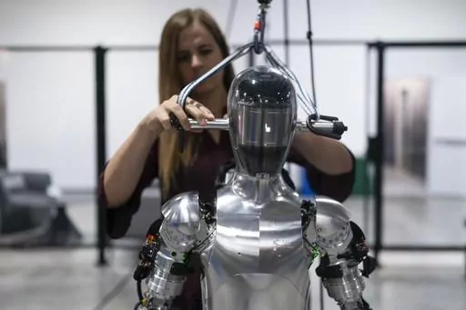 AI engineer Jenna Reher works on humanoid robot Figure 01 at Figure AI's test facility in Sunnyvale, Calif., Oct. 3, 2023. ChatGPT-maker OpenAI is looking to fuse its artificial intelligence systems into the bodies of humanoid robots as part of a new deal with robotics startup Figure. Sunnyvale, California-based Figure announced the partnership Thursday, Feb. 29, 2024, along with $675 million in venture capital funding from a group that includes Amazon founder Jeff Bezos as well as Microsoft, ch