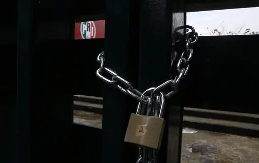 The doors of the headquarters of Mexico's Institutional Revolutionary Party, PRI, remain closed with chains in Mexico City, Wednesday, June 30, 2021. The PRI has been reduced to a shadow of its former self by the rise of President Andrés Manuel López Obrador's Morena party, which won the governorship of the last major PRI bastion, the State of Mexico, on June 2023. (AP Photo/Marco Ugarte, File)