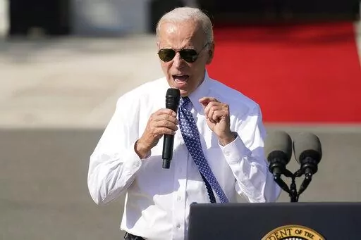President Joe Biden speaks about the reducing inflation during a ceremony on the South Lawn of the White House in Washington, Sept. 13, 2022. Whenever the president travels, a special bullet-resistant lectern called the “blue goose,” or its smaller cousin “the falcon,” is in tow. Lately,  Biden is rendering them all but obsolete as he increasingly reaches for a hand-held microphone instead.  Those who know him best say the mic swap makes Biden a much more natural speaker. (AP Photo/Andre