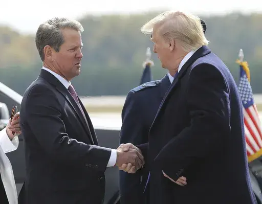 Georgia Gov. Brian Kemp, left, greets President Donald Trump as he arrives at Dobbins Air Reserve Base, Nov. 8, 2019, in Marietta, Ga. (Curtis Compton/Atlanta Journal-Constitution via AP, File)