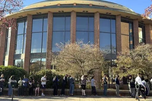 Voters line up outside the Bucks County Administration Building during early voting in the general election, Friday, Nov. 1, 2024, in Doylestown, Pa. (AP Photo/Michael Rubinkam)