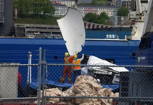 FILE-Debris from the Titan submersible, recovered from the ocean floor near the wreck of the Titanic, is unloaded from the ship Horizon Arctic at the Canadian Coast Guard pier in St. John's, Newfoundland, Wednesday, June 28, 2023. The deadly implosion of an experimental submersible en route to the deep-sea grave of the Titanic last June has not dulled the desire for deep-sea exploration. Tuesday, June 18, 2024, marks one year since the Titan vanished on its way to the historic wreckage site. (Pa
