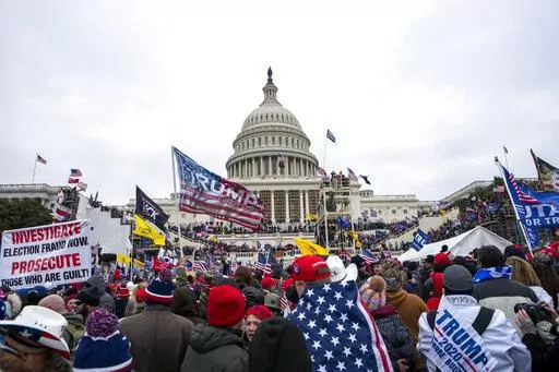 Rioters loyal to President Donald Trump rally at the U.S. Capitol in Washington on Jan. 6, 2021. A trial starts this week for a former Virginia police officer charged with storming the U.S. Capitol with a fellow officer who has agreed to cooperate with federal prosecutors. Jury selection is scheduled to begin Monday, April 4, 2022, for the case against former Rocky Mount police officer Thomas Robertson. (AP Photo/Jose Luis Magana, File)