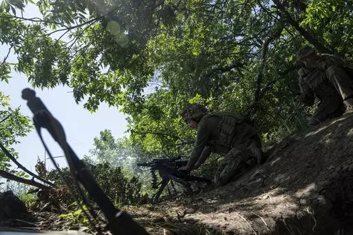 A Ukrainian marine of 35th brigade fires by automatic grenade launcher AGS-17 towards Russian positions on the outskirts of Avdiivka, Ukraine, on June 19, 2023. Ukrainian troops are under intense pressure from a determined Russian effort to storm the strategically important eastern Ukraine city of Avdiivka, officials say. Kyiv’s army is struggling with ammunition shortages as the Kremlin’s forces pursue a battlefield triumph around the two-year anniversary of Moscow’s full-scale invasion a