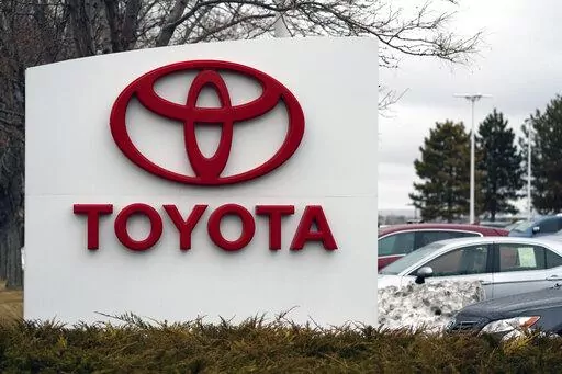 In this Sunday, March 21, 2021, photo, the company logo adorns a sign outside a Toyota dealership in Lakewood, Colo. Toyota customers soon won’t be able to get U.S. federal tax credits for buying electric or plug-in hybrid vehicles. Toyota's sales chief for North American, Bob Carter, said Wednesday, April 6, 2022, that the automaker expects to reach a 200,000-vehicle cap on the credits before the end of June. (AP Photo/David Zalubowski, File)