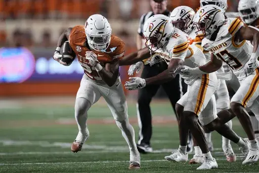 Texas running back Jaydon Blue (23) runs past Louisiana-Monroe defensive back Wydett Williams Jr. (12) and other defenders during the second half of an NCAA college football game in Austin, Texas, Saturday, Sept. 21, 2024. (AP Photo/Eric Gay)