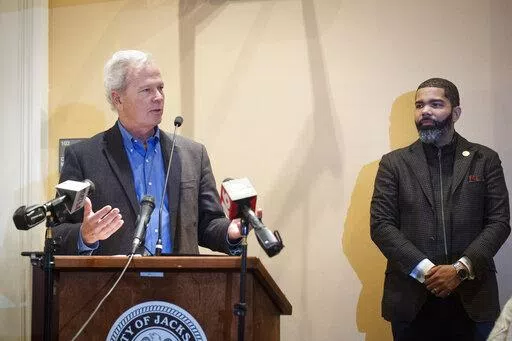 Ted Henifin, left, the City of Jackson water system third-party administrator, addresses media questions during a news conference at City Hall as Jackson Mayor Chokwe Antar Lumumba listens on Dec. 5, 2022, in Jackson, Miss. A bill before the Mississippi Legislature that would transfer the capital city's troubled water system to a new regional entity could be motivated by a desire by state officials to access a large pot of federal dollars earmarked for the city, according to Henifin, Jackson's f