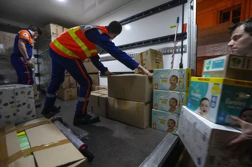 Volunteers of the civil protection load humanitarian aid onto a truck for the victims affected by the Russian invasion in Saint-Cloud, west of Paris, Thursday, March 3, 2022.   Charities say they cannot send humanitarian aid into Ukraine through normal channels, with ports blocked and roads made treacherous by bombings. Even the International Committee of the Red Cross is concerned by the conflict being carried out in densely populated areas and the dangers that poses to children, the sick and t