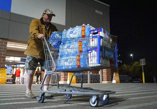 John Beezley, of Bonham, carts out several cases of water after learning that a boil water notice was issued for the entire city of Houston on Sunday, Nov. 27, 2022, at Walmart on S. Post Oak Road in Houston. Beezley just arrived in town with his wife, who is undergoing treatment starting tomorrow at M.D. Anderson Cancer Center, where they are staying in a camping trailer. They turned on the television after settling in and saw that a boil water notice had been issued. Beezley decided to go out 