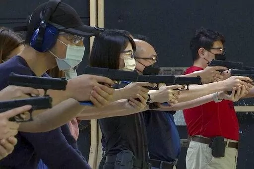 People shoot air soft guns at a private civilian training organization named Polar Light Training in New Taipei City, Taiwan on June 21, 2022. While an invasion doesn’t appear imminent, China's recent large-scale military exercises in response to a visit by U.S. House Speaker Nancy Pelosi to Taiwan have made the government in Taipei more aware than ever of the hard power behind Beijing’s rhetoric about bringing the self-ruled island under its control. Experts said that civilian defense and r