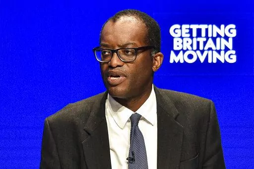 Britain's Chancellor of the Exchequer Kwasi Kwarteng speaks at the Conservative Party conference at the ICC in Birmingham, England, Monday, Oct. 3, 2022. The British government has dropped plans to cut income tax for top earners, part of a package of unfunded cuts that sparked turmoil on financial markets and sent the pound to record lows. (AP Photo/Rui Vieira)