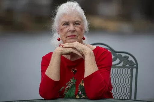 Wanda Olson poses for a photo, Friday, Dec. 17, 2021, in Villa Rica, Ga. When Olson’s son-in-law died in March after contracting COVID-19, she and her daughter had to grapple with more than just their sudden grief. They had to come up with money for a cremation. Even without a funeral, the bill came to nearly $2,000, a hefty sum that Olson initially covered. (AP Photo/Mike Stewart)