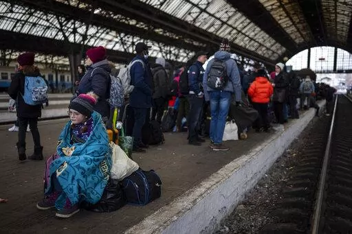 Passengers wait at the platform inside Lviv railway station, Sunday, Feb. 27, 2022, in Lviv, west Ukraine. (AP Photo/Bernat Armangue)