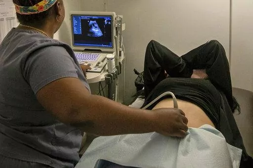 An operating room technician performs an ultrasound on a patient at an abortion clinic in Shreveport, La., Wednesday, July 6, 2022. Serious pregnancy complications are rare in the United States but they still affect thousands of women each year. (AP Photo/Ted Jackson, File)