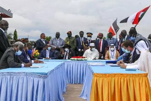 The then head of Sudan's sovereign council, Gen. Abdel-Fattah Burhan, seated center-left, President of South Sudan Salva Kiir, seated center, and then President of Chad Idriss Deby, seated center-right, attend a ceremony to sign a peace deal between Sudan's transitional authorities and a rebel alliance, in Juba, South Sudan, on Oct. 3, 2020.  In a report to the U.N. Security Council circulated Friday, Feb. 4, 2022, its experts say rebel groups in Darfur that signed a peace agreement with the Sud