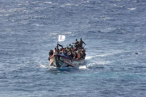 CORRECTS TO DELETE THE EXTRANEOUS WORD OF "UNAUTHORIZED" FROM THE SUBJECTS - FILE - Migrants crowd a wooden boat as they sail to the port in La Restinga on the Canary island of El Hierro, Spain, on Aug. 18, 2024. (AP Photo/Maria Ximena, File)