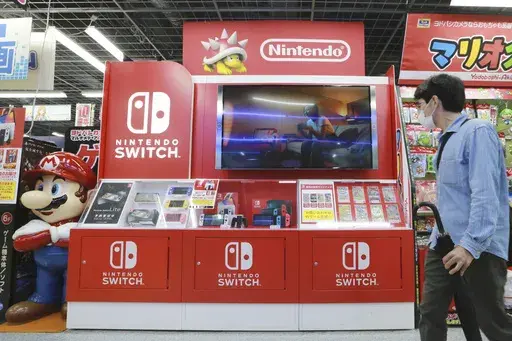 A man walks by a Nintendo Switch display at an electronics retail chain store in Tokyo, on Oct. 13, 2021. (AP Photo/Koji Sasahara, File)