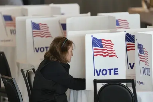 A voter fills out her ballot for the Michigan primary election in Grosse Pointe Farms, Mich., Tuesday, Feb. 27, 2024. (AP Photo/Paul Sancya, File)
