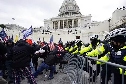 Trump supporters try to break through a police barrier at the Capitol in Washington on Jan. 6, 2021. An Alabama man who parked a pickup truck filled with weapons and Molotov cocktail components near the U.S. Capitol on the day of last year's riot was sentenced Friday, April 1, 2022, to nearly four years in prison. (AP Photo/Julio Cortez, File)