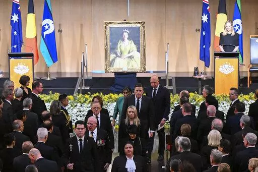 Australian Governor-General David Hurley, center left, and Australian Prime Minister Anthony Albanese, rear center left, leave at the end of the national memorial service for Queen Elizabeth II at Parliament House in Canberra, Thursday, Sept. 22, 2022. An Australian national day of mourning for the late Queen Elizabeth II on Thursday centered on Parliament House, where dignitaries placed sprigs of golden wattle, the national floral emblem, in a wreath. (Lukas Coch/AAP Image via AP)