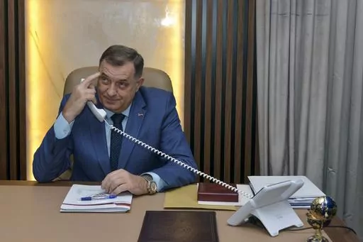 Bosnian Serb leader Milorad Dodik uses his phone prior to the start an interview with the Associated Press, in the Bosnian town of Banja Luka, 240 kms northwest of Sarajevo, Friday, Dec. 29, 2023. Bosnian Serb separatist leader wowed to carry on weakening his multiethnic, war-scarred country to the point where it will tear apart, despite the pledge by the United States to prevent such an outcome. "I am not irrational, I know that America's response will be to use force…but I have no reason to 