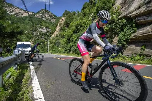 Members of the Qiyi bicycle club climb a hill on a rural road during a group ride through the Baihe River Canyon in the northern outskirts of Beijing, Wednesday, July 13, 2022. Cycling has gained increasing popularity in China as a sport. A coronavirus outbreak that shut down indoor sports facilities in Beijing earlier this year encouraged people to try outdoor sports including cycling, which was only a major tool of transport before 2000. (AP Photo/Mark Schiefelbein)