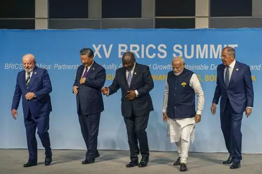 FILE- From left, Brazil's President Luiz Inacio Lula da Silva, China's President Xi Jinping, South Africa's President Cyril Ramaphosa, India's Prime Minister Narendra Modi and Russia's Foreign Minister Sergei Lavrov pose for a BRICS group photo during the 2023 BRICS Summit in Johannesburg, South Africa, Aug. 23, 2023. Modi says his country is “becoming the voice of the Global South,” and that at the upcoming Group of 20 meetings being held in New Delhi that voice will be heard. At the recent