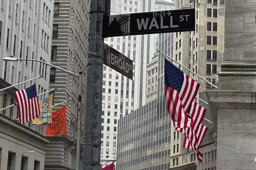 American flags hang from the front the New York Stock Exchange, right, on April 11, 2024 in New York. Global shares are trading higher on Friday, May 10, 2024, after a rally on Wall Street that pulled the S&P 500 back within 1% of its record. (AP Photo/Peter Morgan, File)