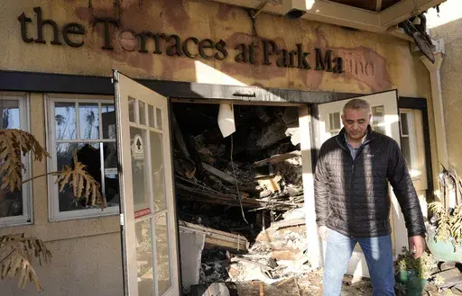 Diversified Healthcare Services President/CEO Adam Khalifa reacts after seeing the damage from the Eaton Fire to The Terraces at Park Marino assisted living facility on Monday, Jan. 13, 2025, in Pasadena, Calif. (AP Photo/Chris Pizzello)