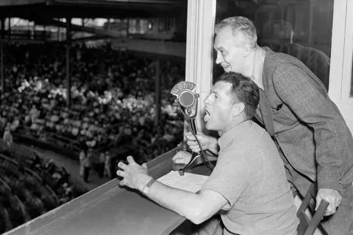 Baseballer Charlie Grimm,left, deposed by the Chicago Cubs in favor of Gabby Hartnett as manager, takes up new duties as a radio broadcaster at the ball games at Wrigley Field in Chicago, July 25, 1938. He's assisted by Pat Flanagan, a broadcasting colleague. Many baseball fans, especially older ones, originally fell in love with America’s pastime by listening to ballgames on AM radio. But several major automakers are eliminating broadcast AM radio from newer models, prompting lawmakers on Cap