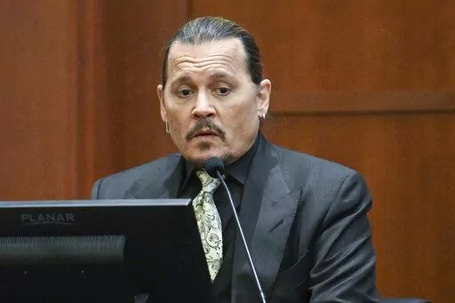 Actor Johnny Depp testifies during a hearing at the Fairfax County Circuit Court in Fairfax, Va., Tuesday April 19, 2022. Actor Johnny Depp sued his ex-wife Heard for libel in Fairfax County Circuit Court after she wrote an op-ed piece in The Washington Post in 2018 referring to herself as a "public figure representing domestic abuse." (Jim Watson/Pool Photo via AP)