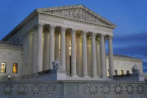 Light illuminates part of the Supreme Court building at dusk on Capitol Hill in Washington on Nov. 16, 2022. The chairman of the Senate Judiciary Committee said his panel is reviewing “serious allegations” in a report Saturday, Nov. 19, 2022, that a former anti-abortion leader knew in advance the outcome of a 2014 Supreme Court case involving health care coverage of contraception. (AP Photo/Patrick Semansky, File)