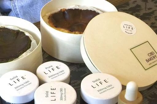 In this image made from a video, cheesecakes made with CBD, CBD powder and water-soluble CBD sold by the CBD Bakery online shop are seen in Hong Kong, Monday, Jan. 30, 2023. Hong Kong banned cannibidiol, also known as CBD, as a "dangerous drug" and imposed harsh penalties for possession on Wednesday, forcing fledging businesses to shut down and revamp. (AP Photo/Alice Fung)