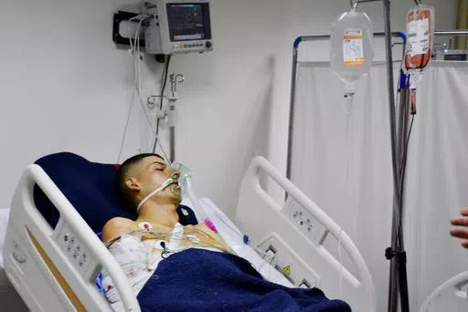 This photo released by the Syrian official news agency SANA shows a Syrian man injured in a drone attack that hit a packed military graduation ceremony in the central city of Homs, Syria, lying in a hospital on Thursday, Oct. 5, 2023. Syria's health minister has raised the casualty tolls from a drone attack that hit a packed military graduation ceremony to 80 killed and 240 wounded. It was one of the deadliest attacks on the Syrian army recently, with its conflict now in its thirteenth year. (SA