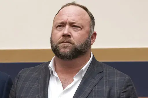 This Tuesday, Dec. 11, 2018, photo shows radio show host and conspiracy theorist Alex Jones at Capitol Hill in Washington. The Sandy Hook families' lawsuits against Infowars host and conspiracy theorist Jones for calling the 2012 Newtown school shooting in Connecticut a hoax appear poised to resume soon. That is based on agreements revealed Friday, May 13, 2022, in a Texas bankruptcy court. (AP Photo/J. Scott Applewhite, File)