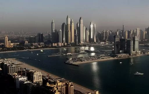 Luxury towers that dominate the skyline in the Dubai Marina district, center, and the new Dubai Harbor development, right, are seen from the observation deck of "The View at The Palm Jumeirah" in Dubai, United Arab Emirates, on April 6, 2021. A senior United Arab Emirates official says the Gulf nation wants a U.N. climate summit it’s hosting later this year to deliver “game-changing results” for international efforts to curb global warming. But UAE diplomat Majid al-Suwaidi said doing so w