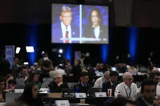 Members of the press work in the spin room during a presidential debate between Republican presidential nominee former President Donald Trump, on screen at left, and Democratic presidential nominee Vice President Kamala Harris, right, Sept. 10, 2024, in Philadelphia. (AP Photo/Matt Slocum, File)