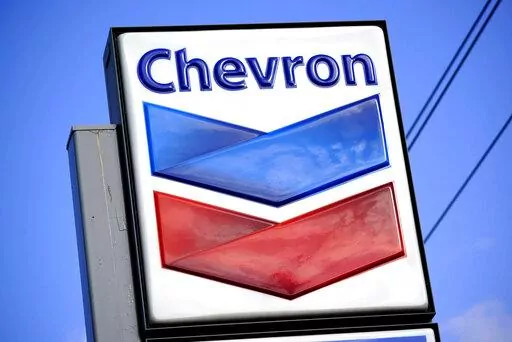 A Chevron sign is displayed outside one of the company's gas stations in Bradenton, Fla., Feb. 22, 2022. The Biden administration is easing some oil sanctions on Venezuela in an effort to support newly restarted negotiations between the Venezuelan government and its opposition. The Treasury Department is allowing Chevron to resume “limited” energy production in Venezuela after years of sanctions that have dramatically curtailed oil and gas profits that have flowed to President Nicolás Madur